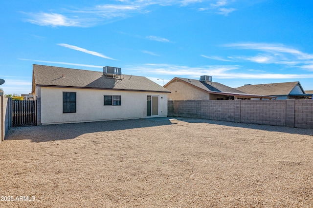 back of house featuring cooling unit