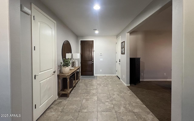 entryway featuring light tile patterned floors, visible vents, and baseboards