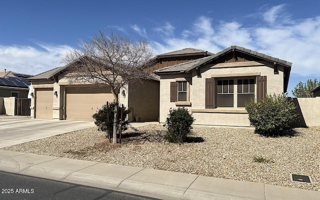 view of front of property with a garage, driveway, and stucco siding