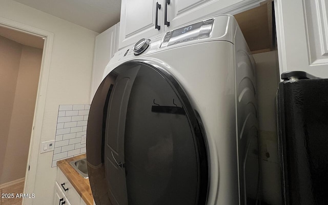 laundry area with washer / clothes dryer and cabinet space