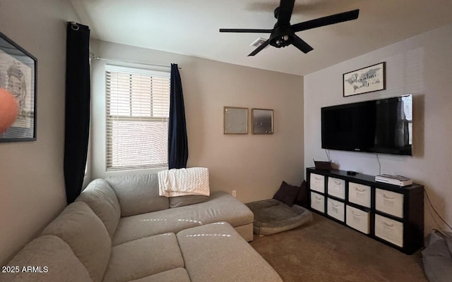 living area featuring carpet and a ceiling fan