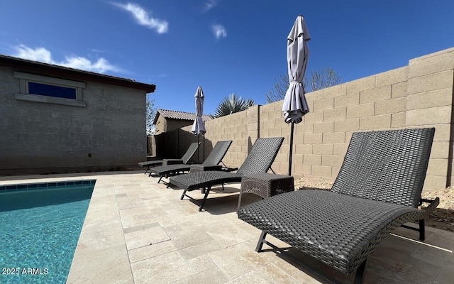 view of patio featuring a fenced in pool and fence