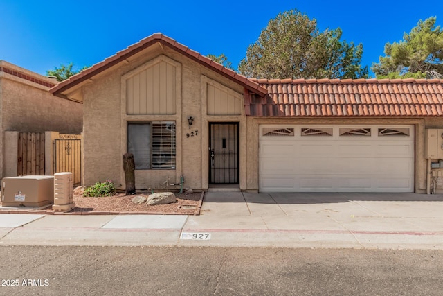 927 E Charleston Ave, Phoenix, AZ 85022 - view of front of home with a tile roof, stucco siding, driveway, and an attached garage