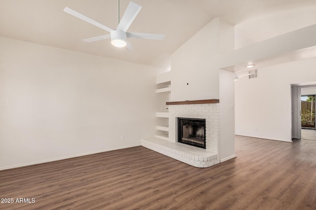927 E Charleston Ave, Phoenix, AZ 85022 - unfurnished living room featuring high vaulted ceiling, wood finished floors, a brick fireplace, ceiling fan, and baseboards