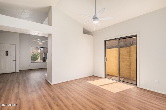 927 E Charleston Ave, Phoenix, AZ 85022 - empty room featuring a ceiling fan, wood finished floors, high vaulted ceiling, and baseboards