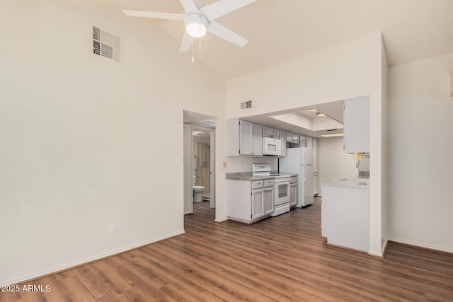 927 E Charleston Ave, Phoenix, AZ 85022 - kitchen featuring white appliances, light countertops, wood finished floors, baseboards, and high vaulted ceiling