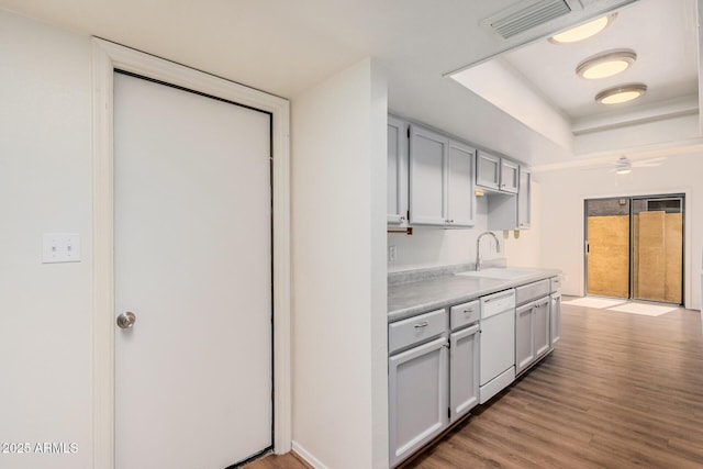 927 E Charleston Ave, Phoenix, AZ 85022 - kitchen featuring a sink, dishwasher, light wood-type flooring, light countertops, and a raised ceiling