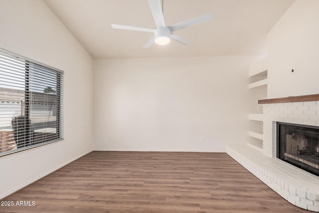 927 E Charleston Ave, Phoenix, AZ 85022 - unfurnished living room featuring ceiling fan, wood finished floors, a fireplace, lofted ceiling, and baseboards