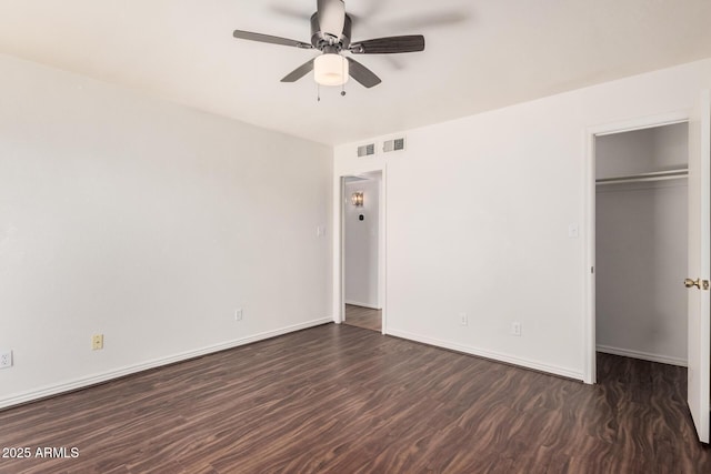 927 E Charleston Ave, Phoenix, AZ 85022 - unfurnished bedroom with a closet, a spacious closet, a ceiling fan, baseboards, and wood finished floors