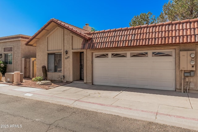 927 E Charleston Ave, Phoenix, AZ 85022 - multi unit property with a tiled roof, driveway, an attached garage, a chimney, and stucco siding