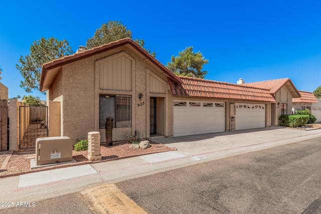 927 E Charleston Ave, Phoenix, AZ 85022 - view of front facade featuring a tiled roof, an attached garage, stucco siding, and concrete driveway