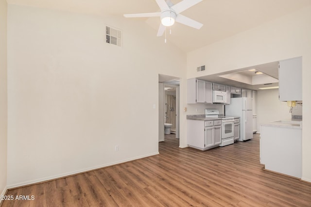 927 E Charleston Ave, Phoenix, AZ 85022 - kitchen featuring white appliances, wood finished floors, ceiling fan, light countertops, and a sink