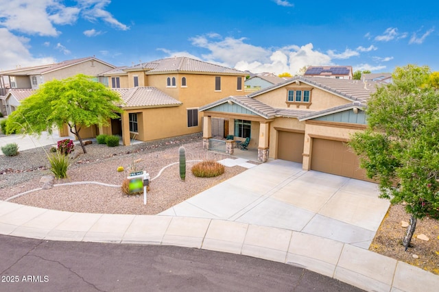 12702 W Dove Wing Way, Peoria, AZ 85383 - view of front facade with a residential view, an attached garage, stucco siding, concrete driveway, and covered porch
