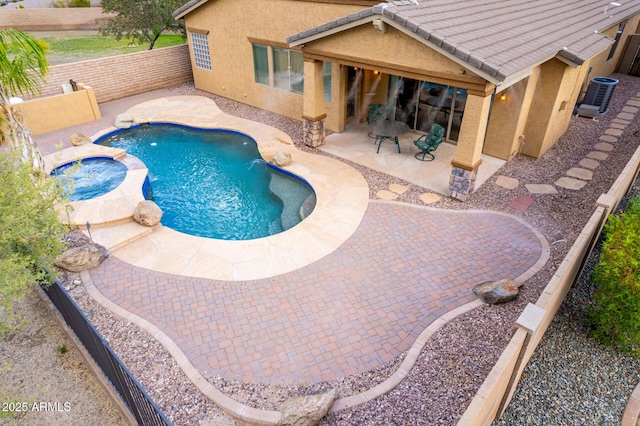 12702 W Dove Wing Way, Peoria, AZ 85383 - view of swimming pool featuring central AC unit, a patio area, a fenced backyard, and a pool with connected hot tub