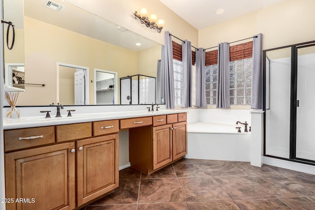 12702 W Dove Wing Way, Peoria, AZ 85383 - bathroom with a sink, a shower stall, double vanity, and visible vents