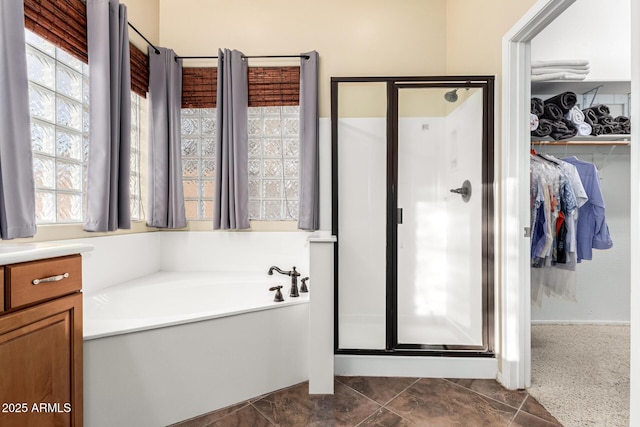 12702 W Dove Wing Way, Peoria, AZ 85383 - bathroom featuring a stall shower, a garden tub, and a spacious closet