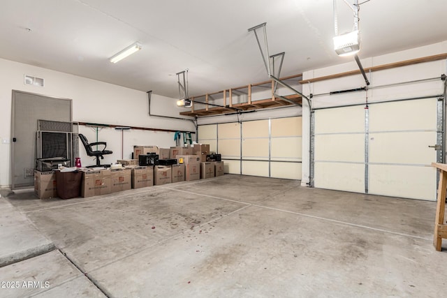 12702 W Dove Wing Way, Peoria, AZ 85383 - garage with visible vents and a garage door opener