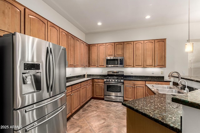 12702 W Dove Wing Way, Peoria, AZ 85383 - kitchen with a sink, brown cabinetry, stainless steel appliances, recessed lighting, and pendant lighting