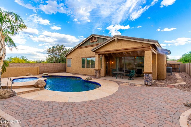 12702 W Dove Wing Way, Peoria, AZ 85383 - view of swimming pool featuring a pool with connected hot tub, a fenced backyard, and a patio area