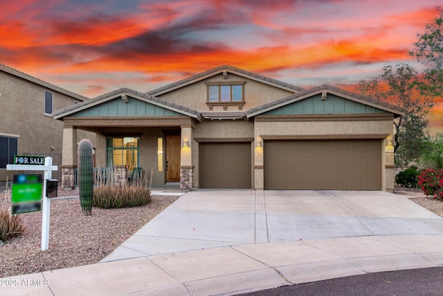 12702 W Dove Wing Way, Peoria, AZ 85383 - craftsman inspired home featuring a porch, an attached garage, stucco siding, and concrete driveway