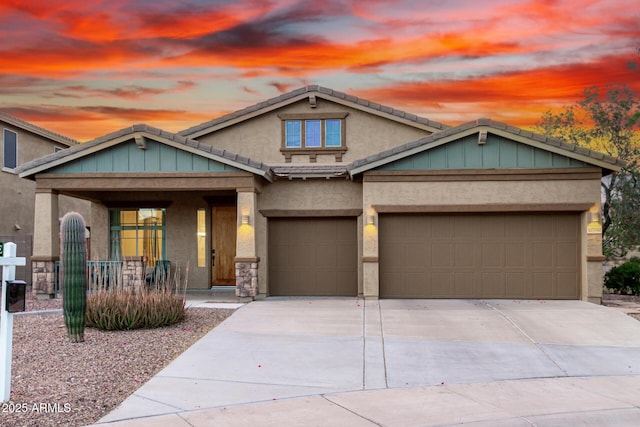 12702 W Dove Wing Way, Peoria, AZ 85383 - craftsman-style house featuring covered porch, a garage, concrete driveway, and stucco siding