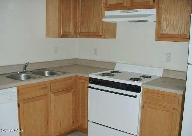 kitchen with sink, white appliances, and ventilation hood