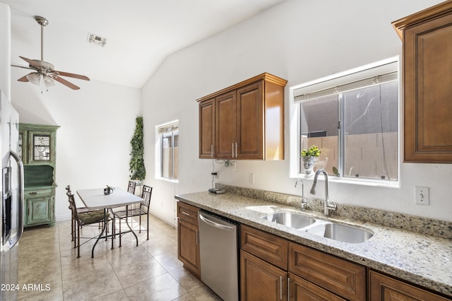 kitchen with stainless steel dishwasher, sink, lofted ceiling, light tile patterned floors, and ceiling fan