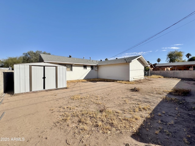 back of property with a storage unit