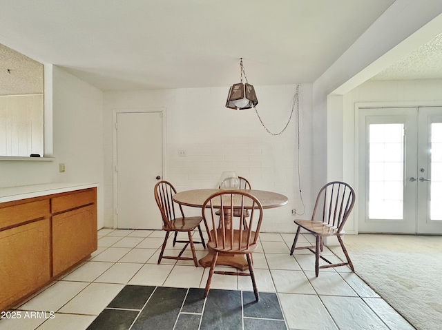 dining space with light colored carpet and french doors