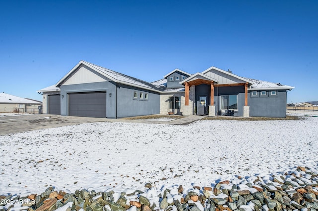 view of front of property featuring concrete driveway and an attached garage