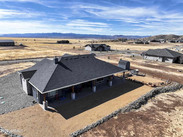 birds eye view of property with a rural view and a mountain view