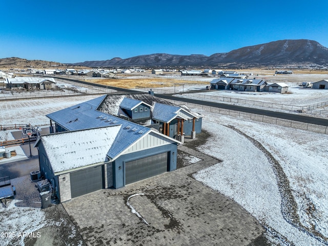 snowy aerial view featuring a mountain view