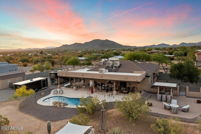 exterior space featuring a mountain view, exterior bar, and a patio area