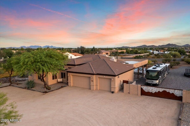 view of front facade with a garage and a mountain view