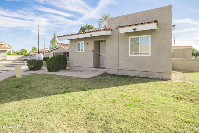 rear view of house with a yard