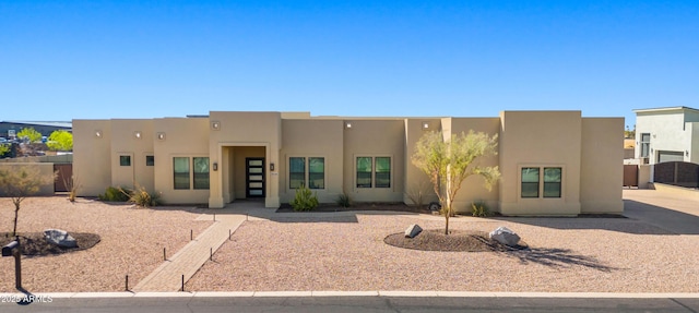 pueblo-style home featuring stucco siding