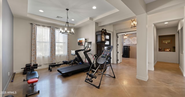 exercise area with baseboards, visible vents, recessed lighting, a raised ceiling, and a chandelier