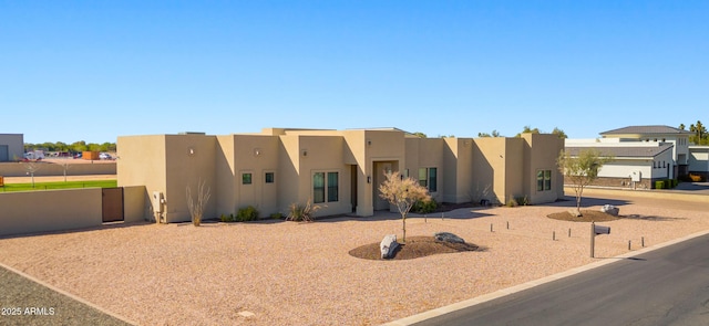 southwest-style home with a residential view and stucco siding