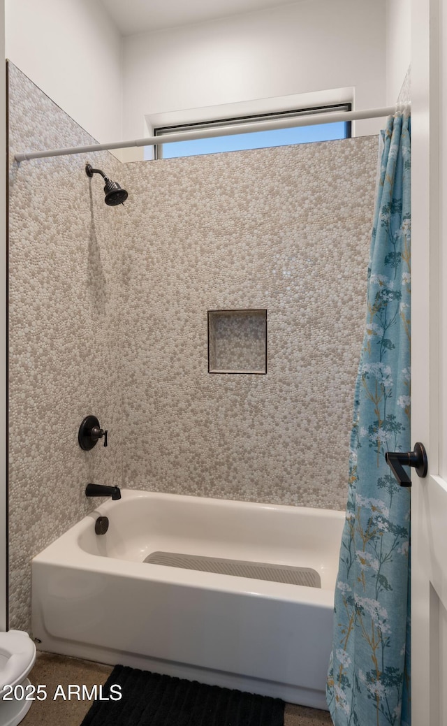 full bath with toilet and shower / bath combo with shower curtain