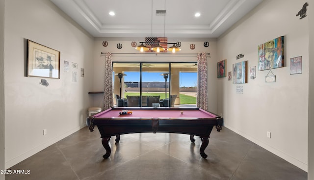 playroom with a tray ceiling, baseboards, and concrete floors