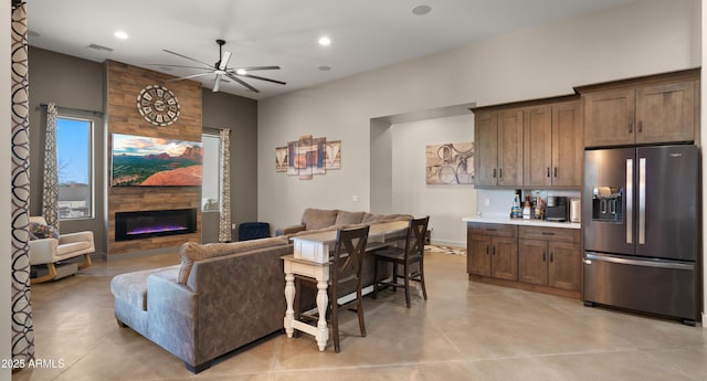 living area with a ceiling fan, visible vents, concrete floors, a fireplace, and recessed lighting