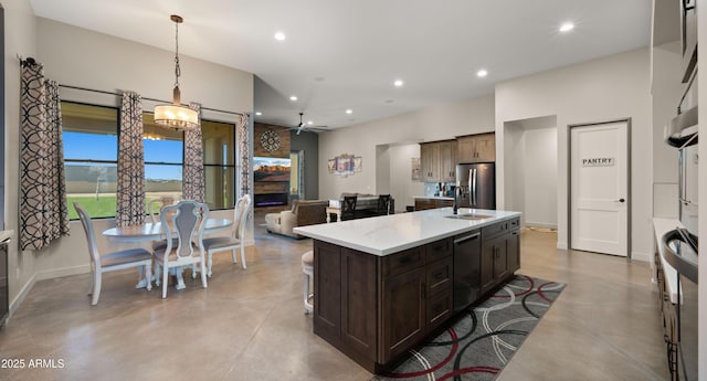 kitchen with light countertops, recessed lighting, stainless steel fridge with ice dispenser, and concrete floors