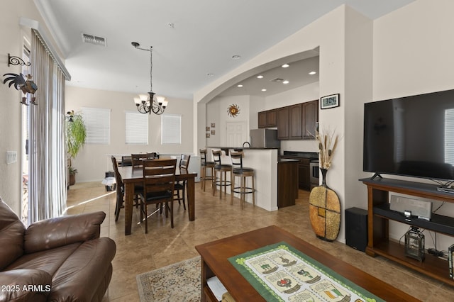 living room featuring light tile patterned floors and a notable chandelier