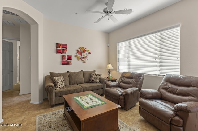 tiled living room with ceiling fan