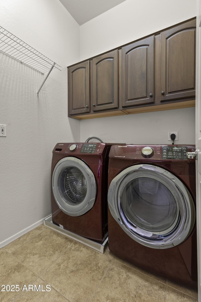 clothes washing area with independent washer and dryer and cabinets