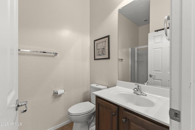 bathroom featuring toilet, vanity, and walk in shower