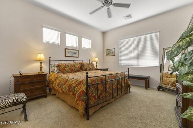 bedroom with ceiling fan and light colored carpet