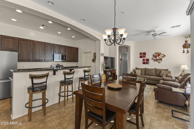 dining space featuring ceiling fan and light tile patterned floors