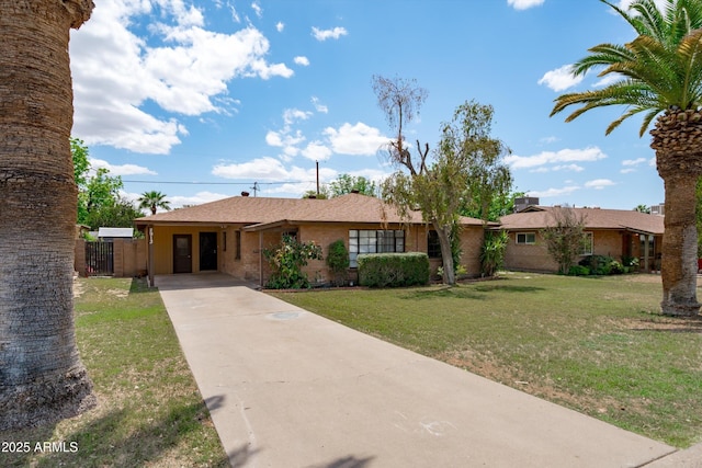 single story home with fence, a front lawn, concrete driveway, and an attached carport