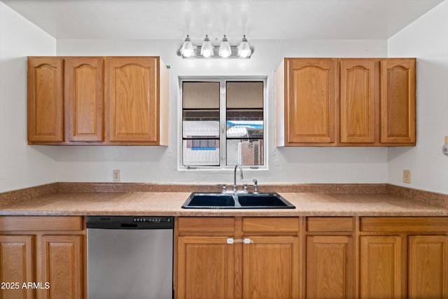 kitchen with brown cabinets, light countertops, dishwasher, and a sink